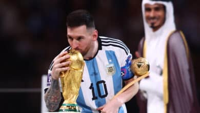 LUSAIL CITY, QATAR - DECEMBER 18: Lionel Messi of Argentina kisses the World Cup trophy as he holds the adidas Golden Ball at the end of the FIFA World Cup Qatar 2022 Final match between Argentina and France at Lusail Stadium on December 18, 2022 in Lusail City, Qatar.