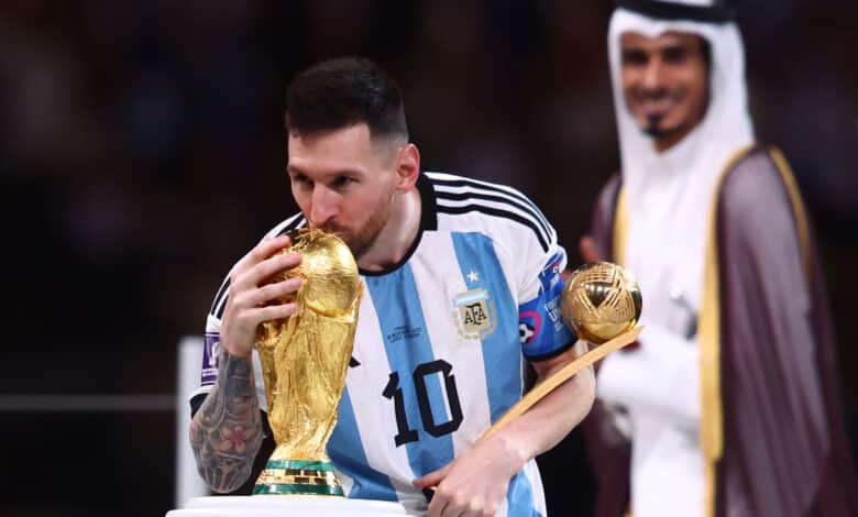 LUSAIL CITY, QATAR - DECEMBER 18: Lionel Messi of Argentina kisses the World Cup trophy as he holds the adidas Golden Ball at the end of the FIFA World Cup Qatar 2022 Final match between Argentina and France at Lusail Stadium on December 18, 2022 in Lusail City, Qatar.
