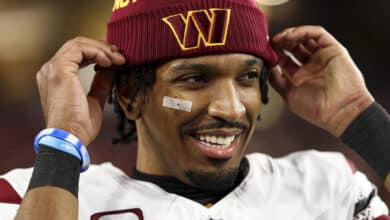 Jayden Daniels #5 of the Washington Commanders smiles after an NFL football wild card playoff game against the Tampa Bay Buccaneers