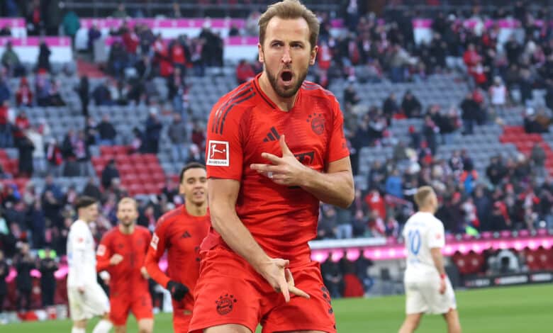 Harry Kane of Bayern Munich celebrates scoring his team's third goal during the Bundesliga match between FC Bayern München and Holstein Kiel