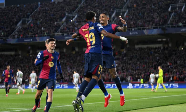 Raphinha of FC Barcelona celebrates scoring his team's first goal with teammate Lamine Yamal during the UEFA Champions League 2024/25 UEFA Champions League 2024/25 Round of 16 Second Leg match between FC Barcelona and SL Benfica at Estadi Olímpic Lluís Companys on March 11, 2025 in Barcelona, Spain.