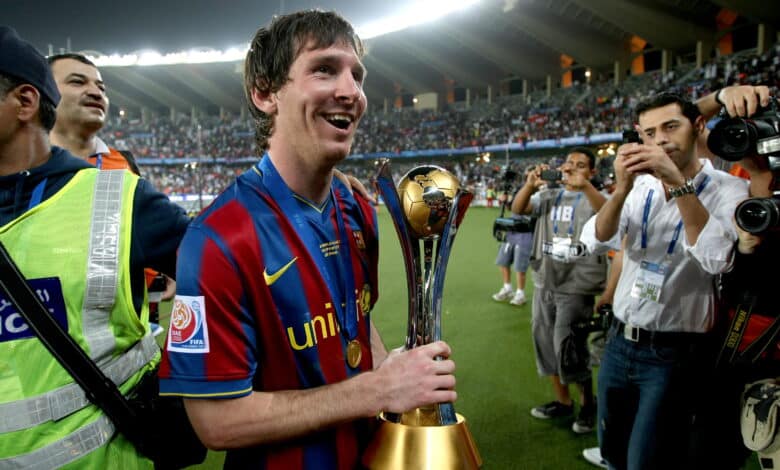 Barcelona's Lionel Messi holds the 2009 FIFA Club World Cup trophy as he celebrates the Spanish club's victory at Zayed Sports City Stadium in Abu Dhabi on December 19, 2009. Barcelona beat Argentina's Estudiantes de La Plata 2-1 in the final football match. AFP PHOTO/MARWAN NAAMANI