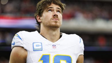 HOUSTON, TEXAS - JANUARY 11: Quarterback Justin Herbert #10 of the Los Angeles Chargers stands on the sidelines during the national anthem prior to an AFC Wild Card game against the Houston Texans, at NRG Stadium on January 11, 2025 in Houston, Texas. (