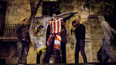 MADRID, SPAIN - MAY 17: Atletico Madrid supporters tears a Real Madrid flag to pieces after they won the Copa del Rey Final game between Real Madrid and Atletico de Madrid at Neptuno Square on May 17, 2013 in Madrid, Spain. Atletico's last victory over Real Madrid was in 1999 and it has been 21 years since the last Madrid derby for a Copa del Rey Final.