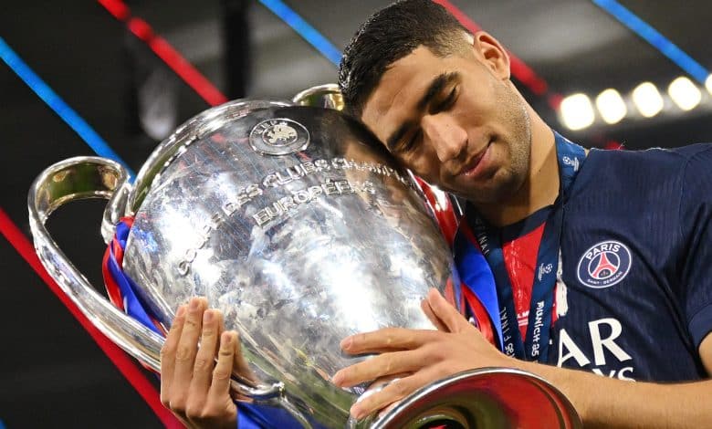 MUNICH, GERMANY - MAY 31: Achraf Hakimi of Paris Saint-Germain celebrates with the UEFA Champions League trophy after his team's victory, to secure Paris Saint-Germain's first ever UEFA Champions League title in the club's history and a record UEFA Champions League Final winning scoreline of 5-0, following the UEFA Champions League Final 2025 between Paris Saint-Germain and FC Internazionale Milano at Munich Football Arena on May 31, 2025 in Munich, Germany.