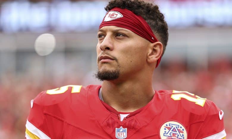 KANSAS CITY, MISSOURI - SEPTEMBER 14: Patrick Mahomes #15 of the Kansas City Chiefs stands on the sideline during the national anthem prior to an NFL football game against the Philadelphia Eagles at GEHA Field at Arrowhead Stadium on September 14, 2025 in Kansas City, Missouri.