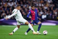 MADRID, SPAIN - OCTOBER 26: Lamine Yamal of FC Barcelona competes for the ball with Kylian Mbappe of Real Madrid during the LaLiga match between Real Madrid CF and FC Barcelona at Estadio Santiago Bernabeu on October 26, 2024 in Madrid, Spain.